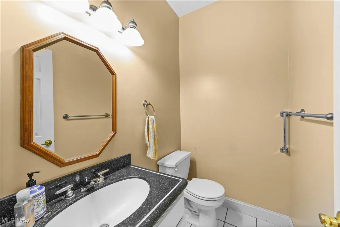Bathroom featuring tile patterned flooring and vanity