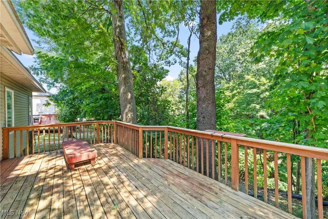 Wooden deck featuring view of scattered trees