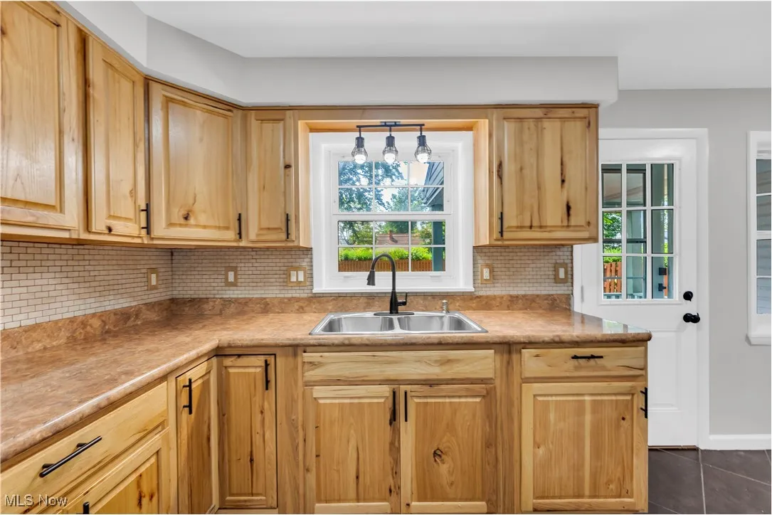 Kitchen with backsplash, plenty of natural light, and light countertops