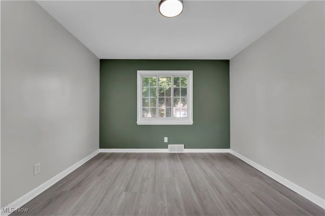 Empty room featuring wood finished floors and baseboards