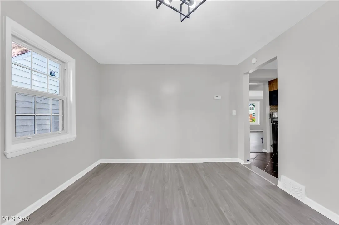 Unfurnished room featuring light wood-type flooring and baseboards