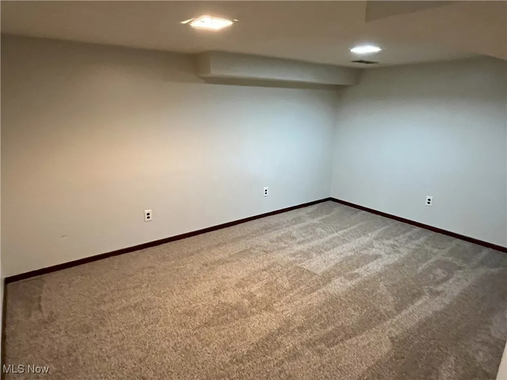 Finished basement with carpet flooring, recessed lighting, andbaseboards