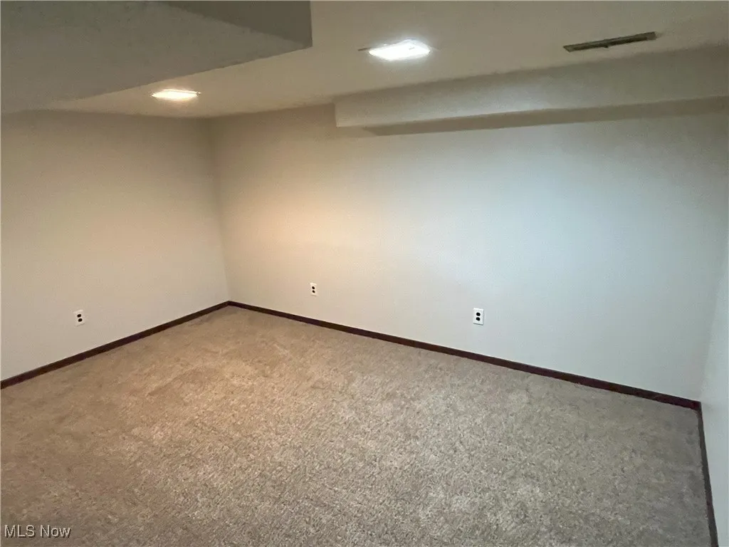 Finished basement with carpet flooring, recessed lighting, andbaseboards