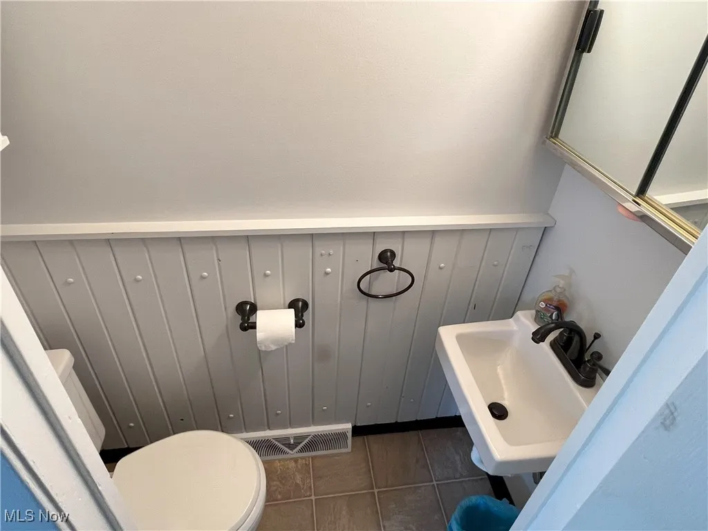 Bathroom with toilet and tile patterned flooring