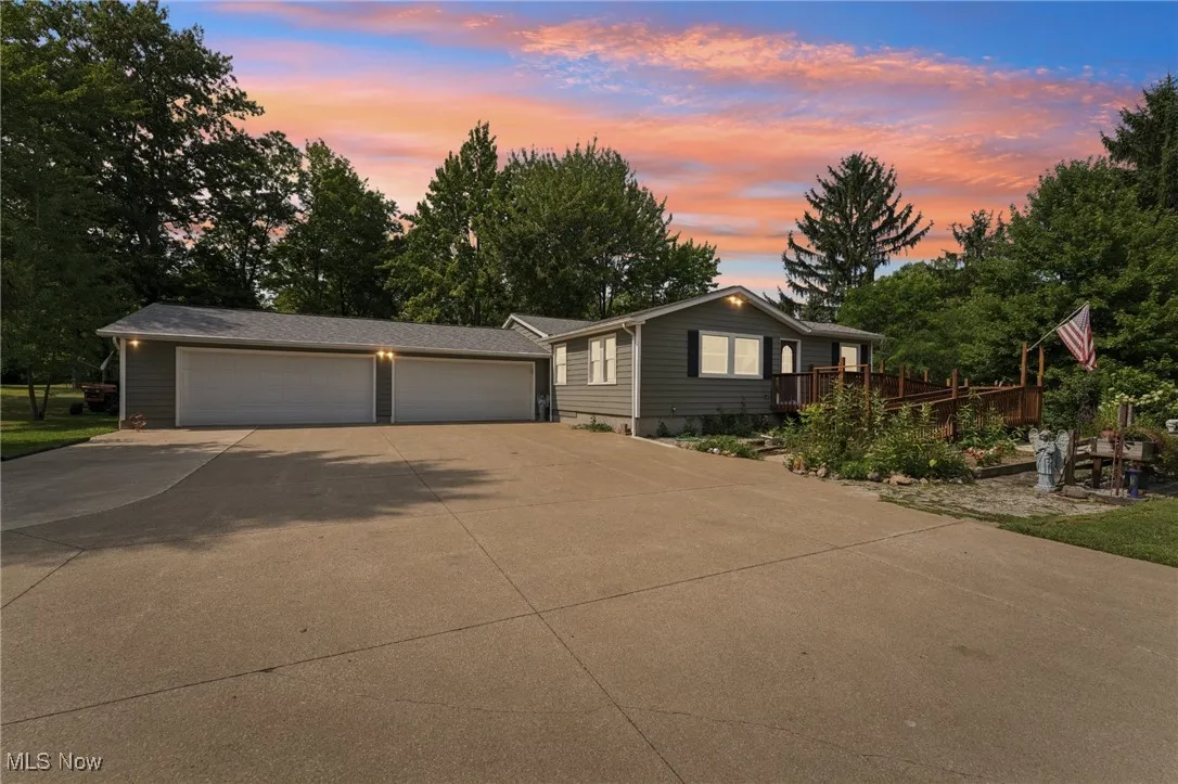 Ranch-style home with driveway and a wooden deck