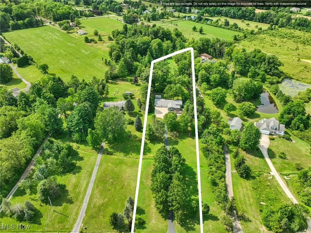 View of property location with property boundaries highlighted and a tree filled landscape