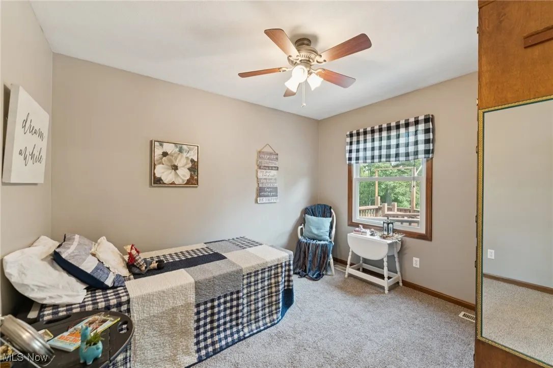 Bedroom with carpet flooring and a ceiling fan
