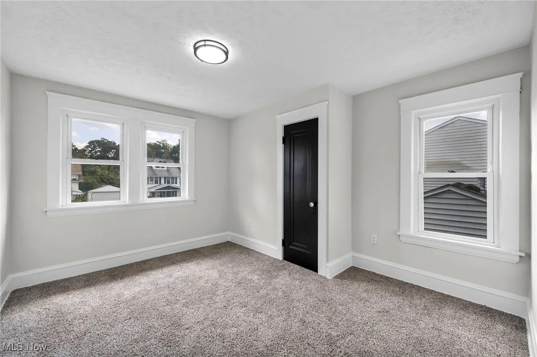 Unfurnished bedroom featuring carpet and a textured ceiling