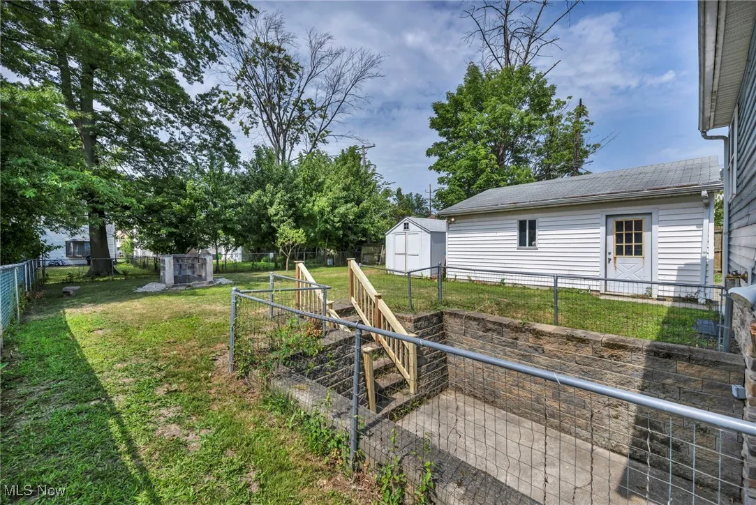 Fenced backyard with a storage unit