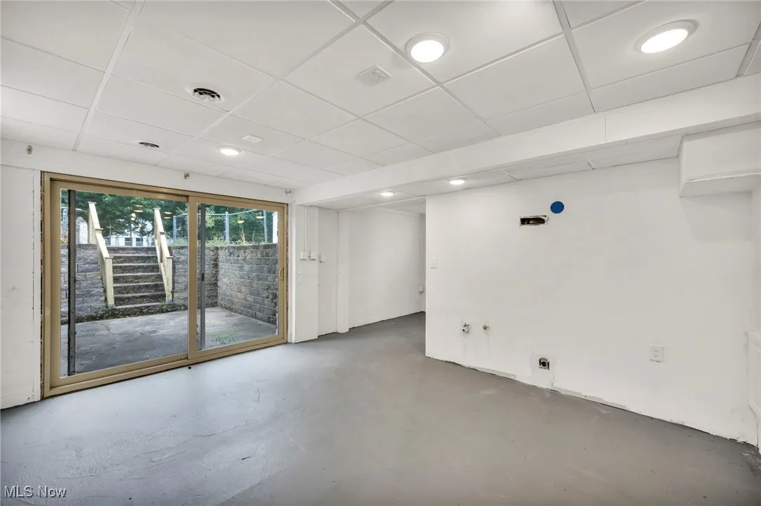 Spare room featuring finished concrete flooring, recessed lighting, and a paneled ceiling