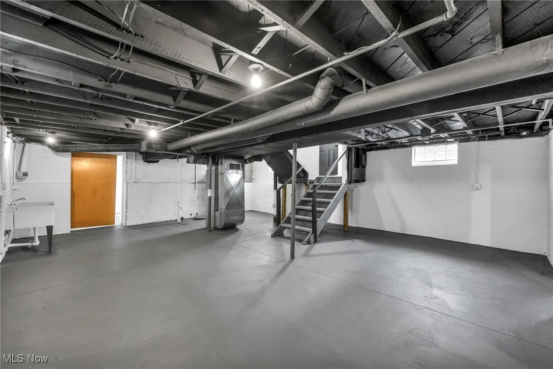 Basement with stairs and heating unit
