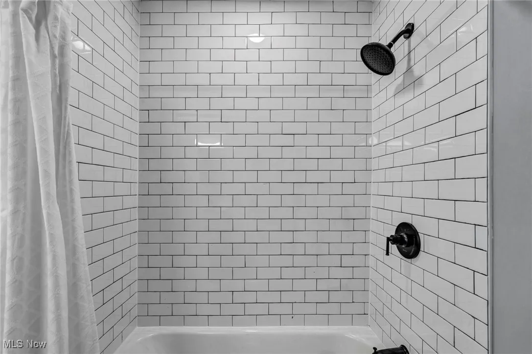 Bathroom featuring shower / bathtub combination with curtain