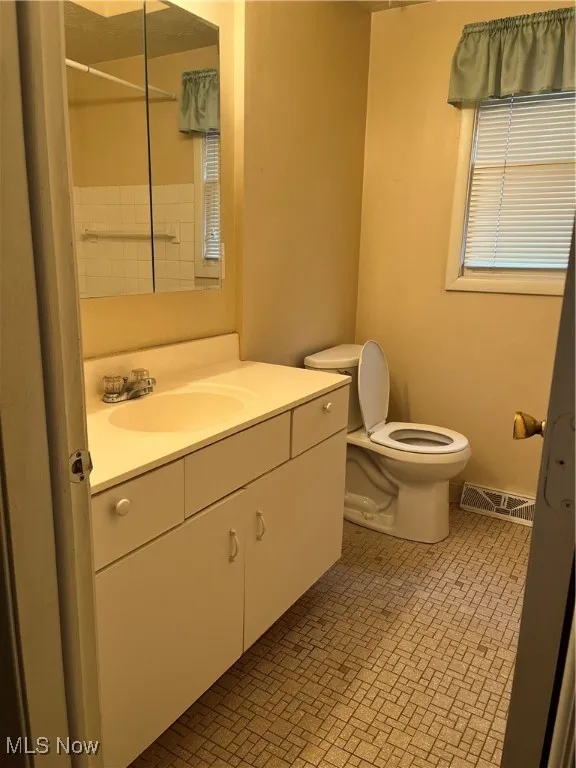 Full bathroom with vanity and toilet