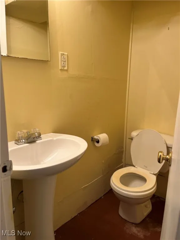Basement-Half bathroom featuring toilet
