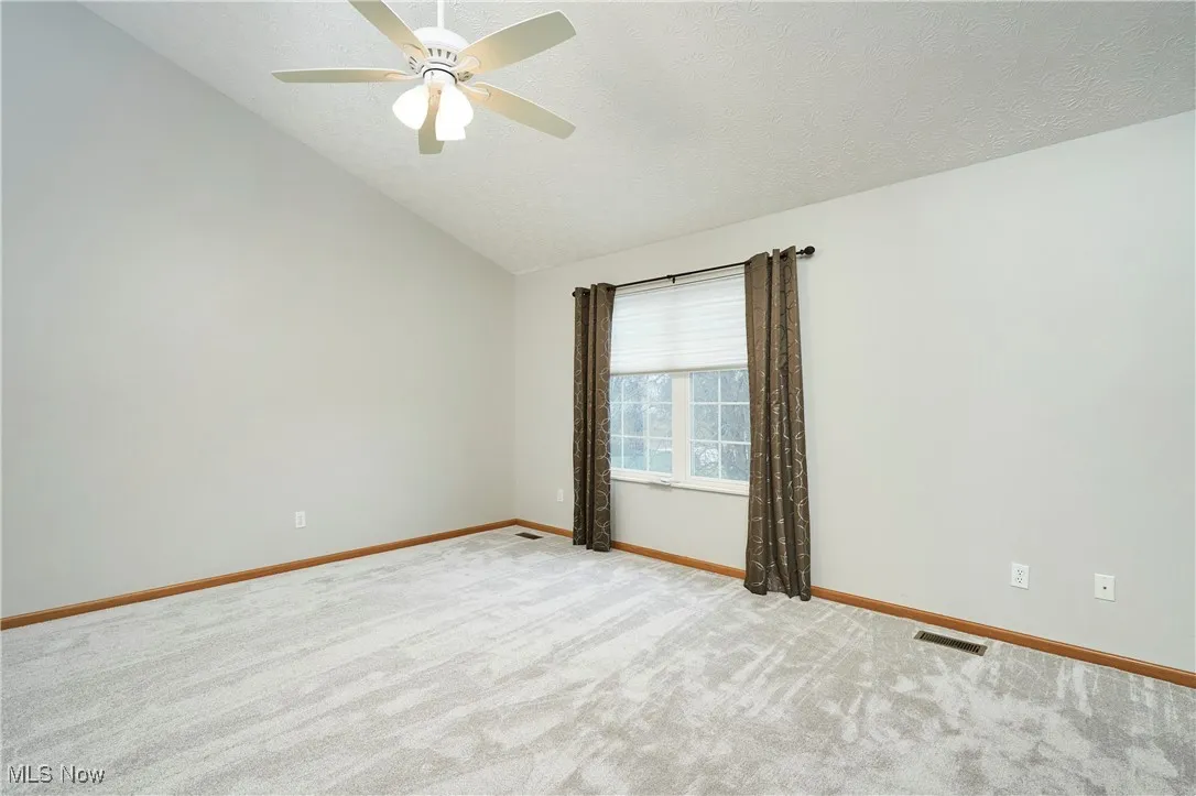 Primary Bedroom with New Carpet, and ceiling fan