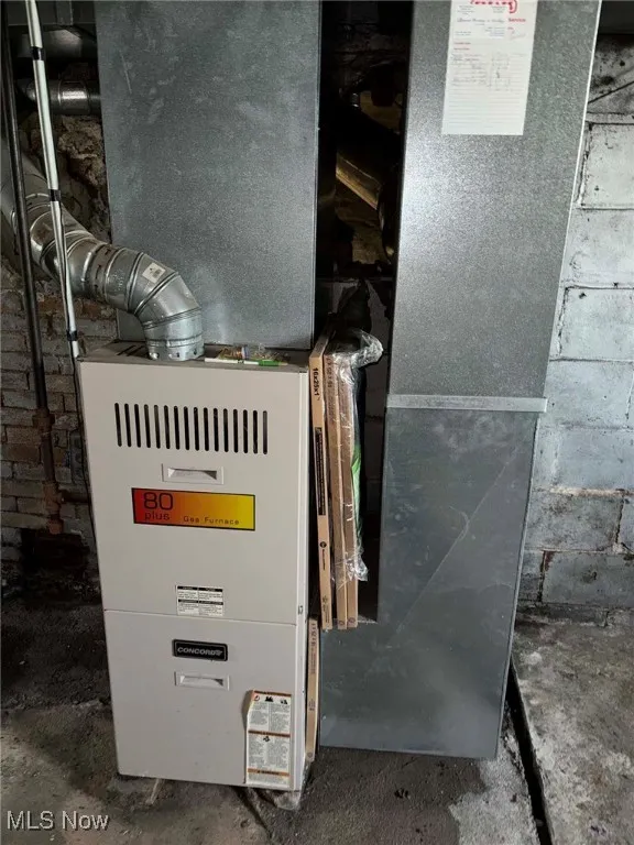 Utility room featuring heating unit