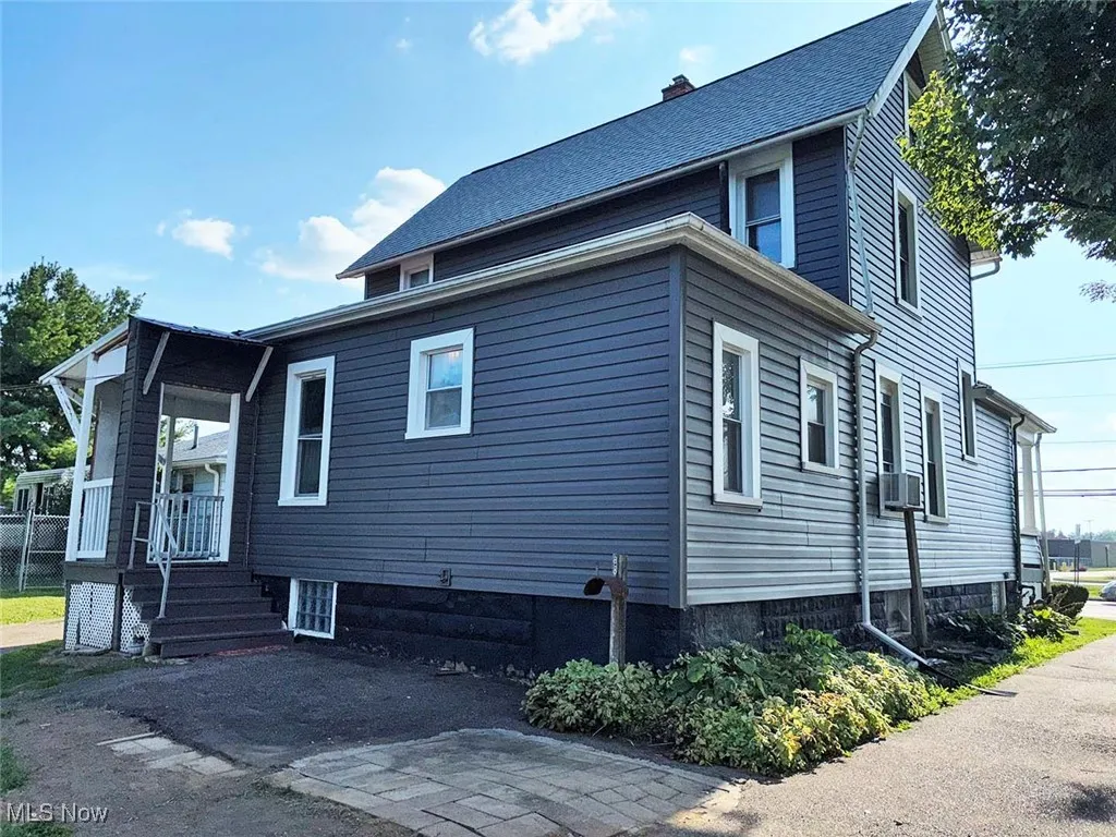 View of side of home featuring a chimney