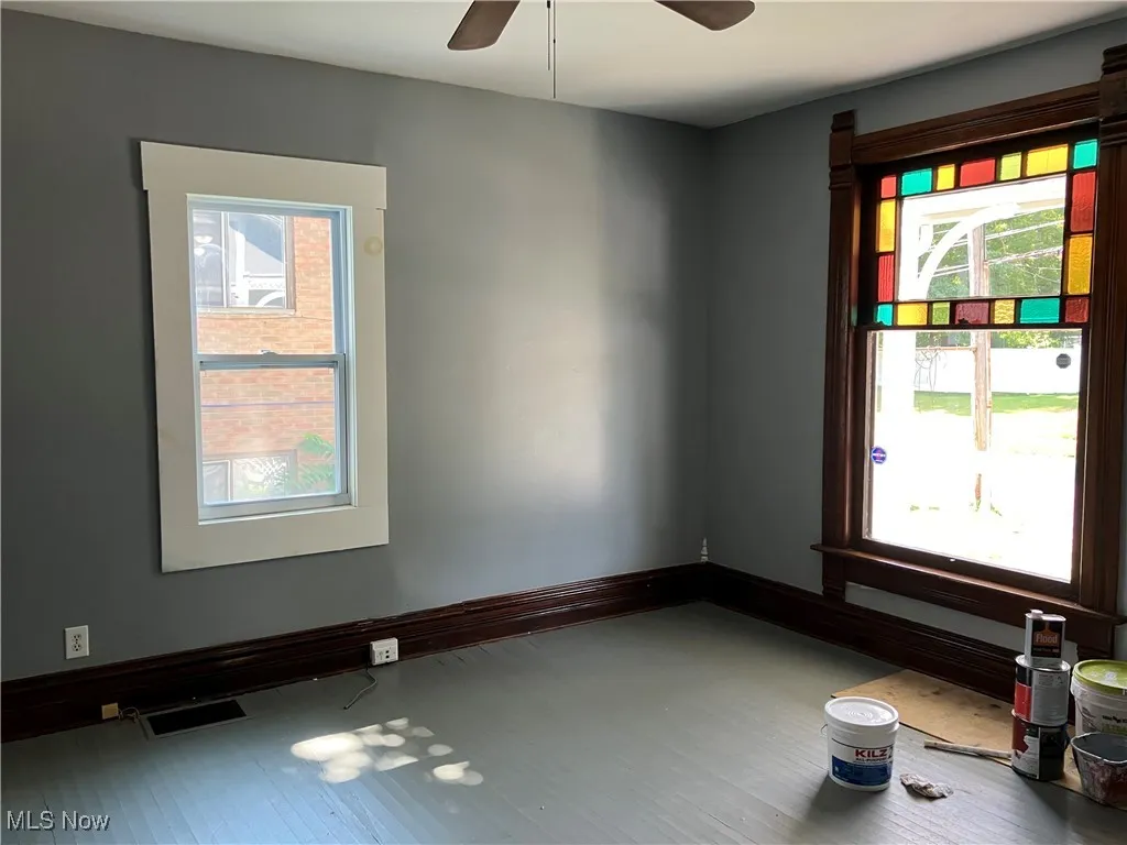 Unfurnished room with baseboards and a ceiling fan