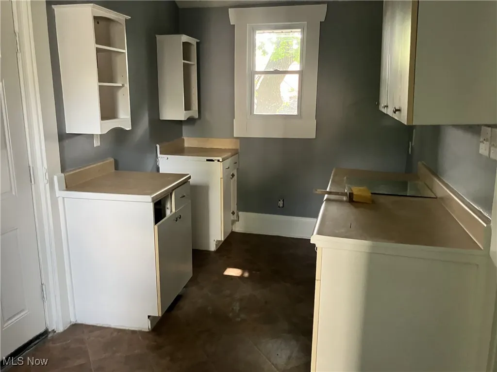 Kitchen with open shelves and white cabinetry