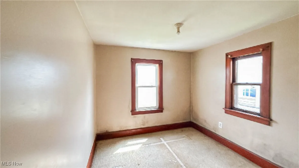 Unfurnished room featuring plenty of natural light