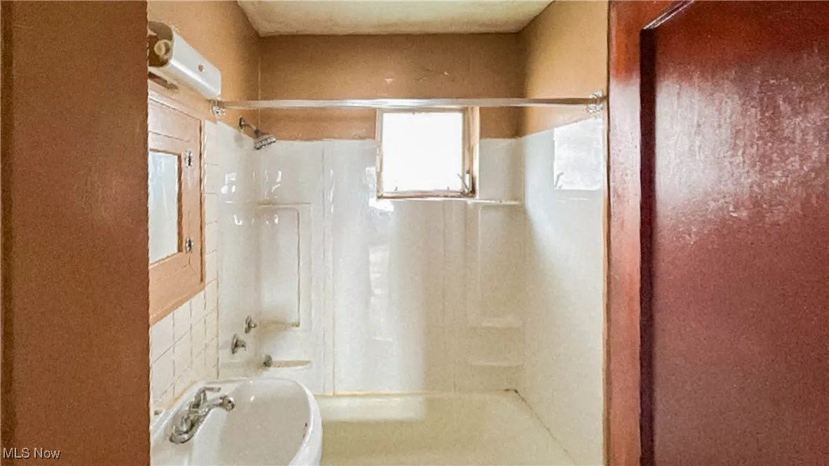 Full bathroom with shower / bath combination and a sink