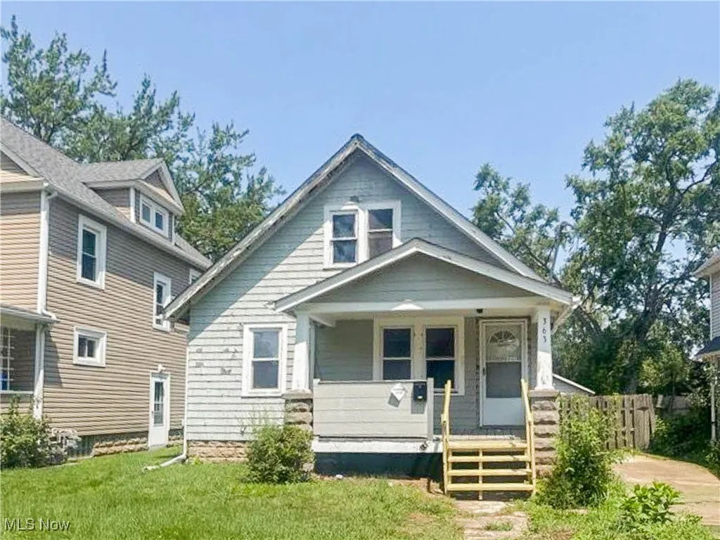 Bungalow-style house with covered porch and a front yard