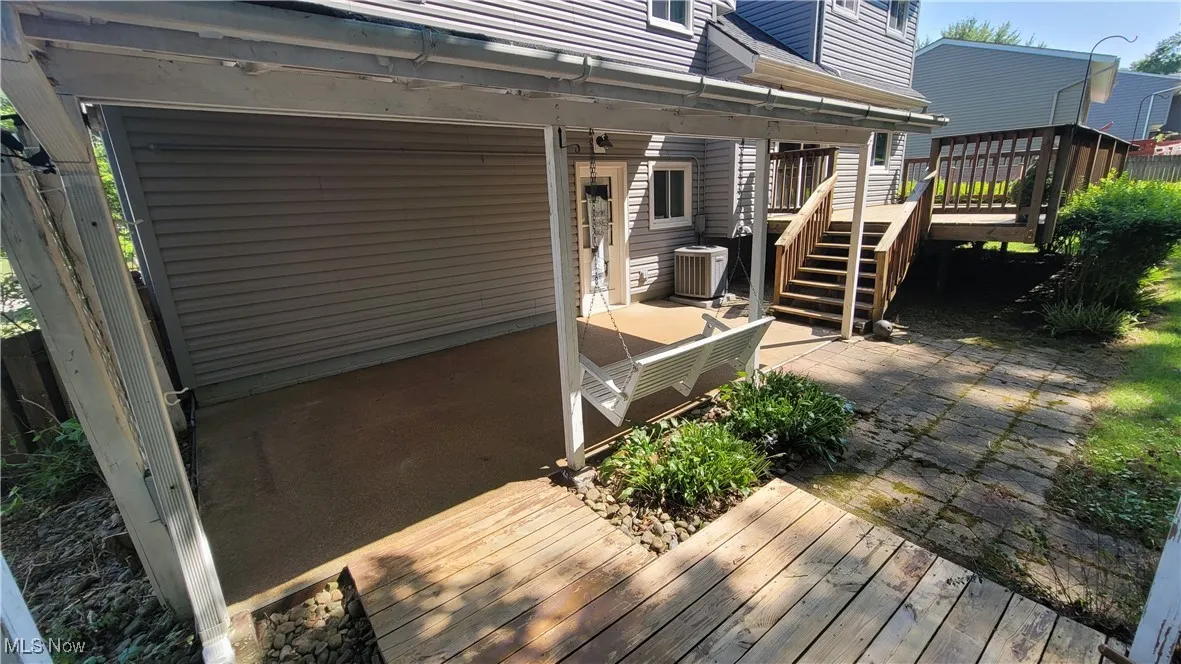 Wooden terrace featuring a patio area and stairway