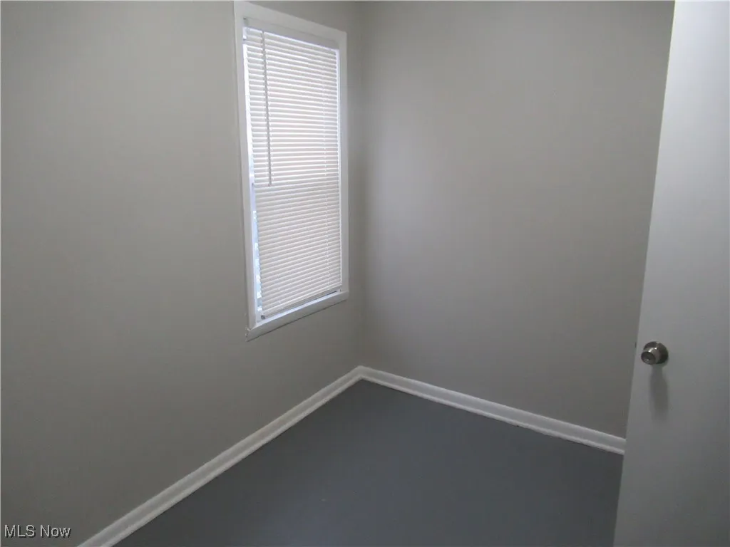 Unfurnished room with baseboards