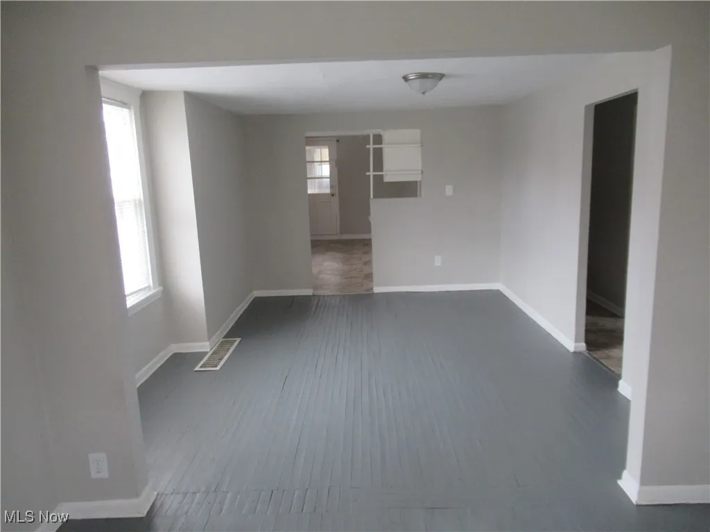 Empty room featuring baseboards and wood finished floors