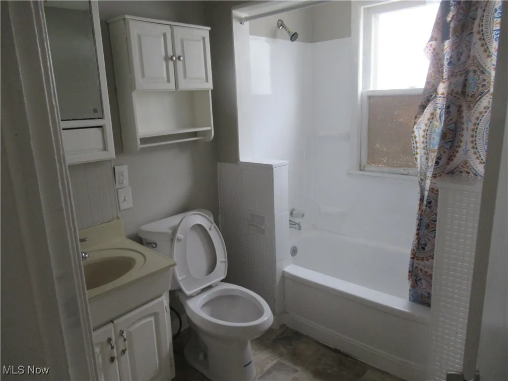 Bathroom featuring shower / tub combo and vanity