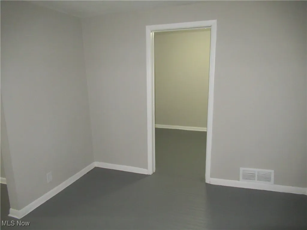 Empty room featuring baseboards
