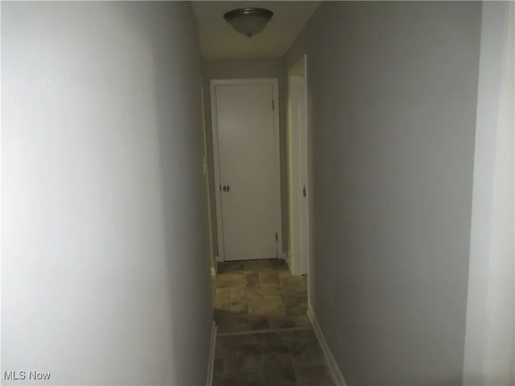 Hallway featuring baseboards