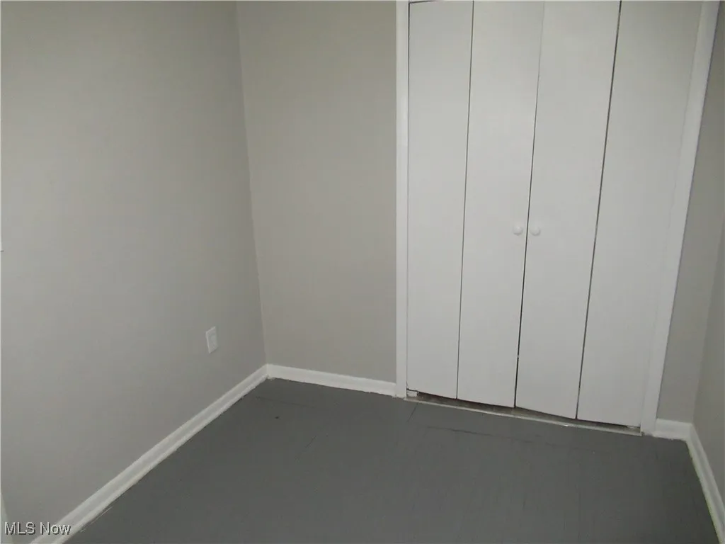 Unfurnished bedroom featuring baseboards and a closet
