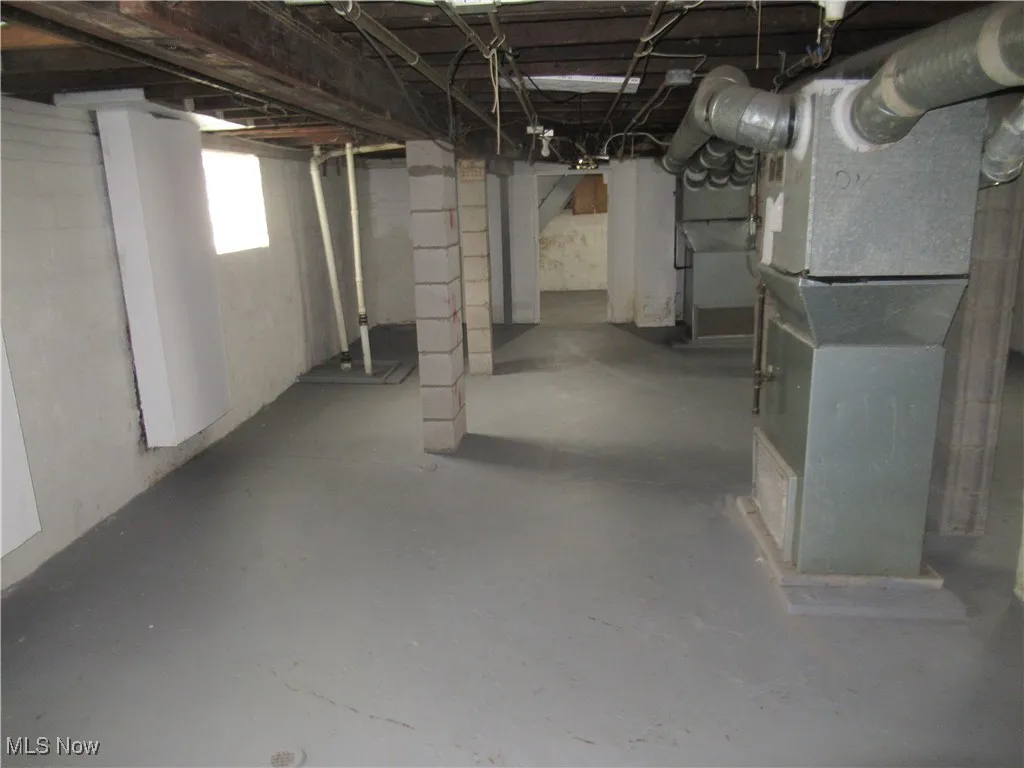 Basement featuring heating unit