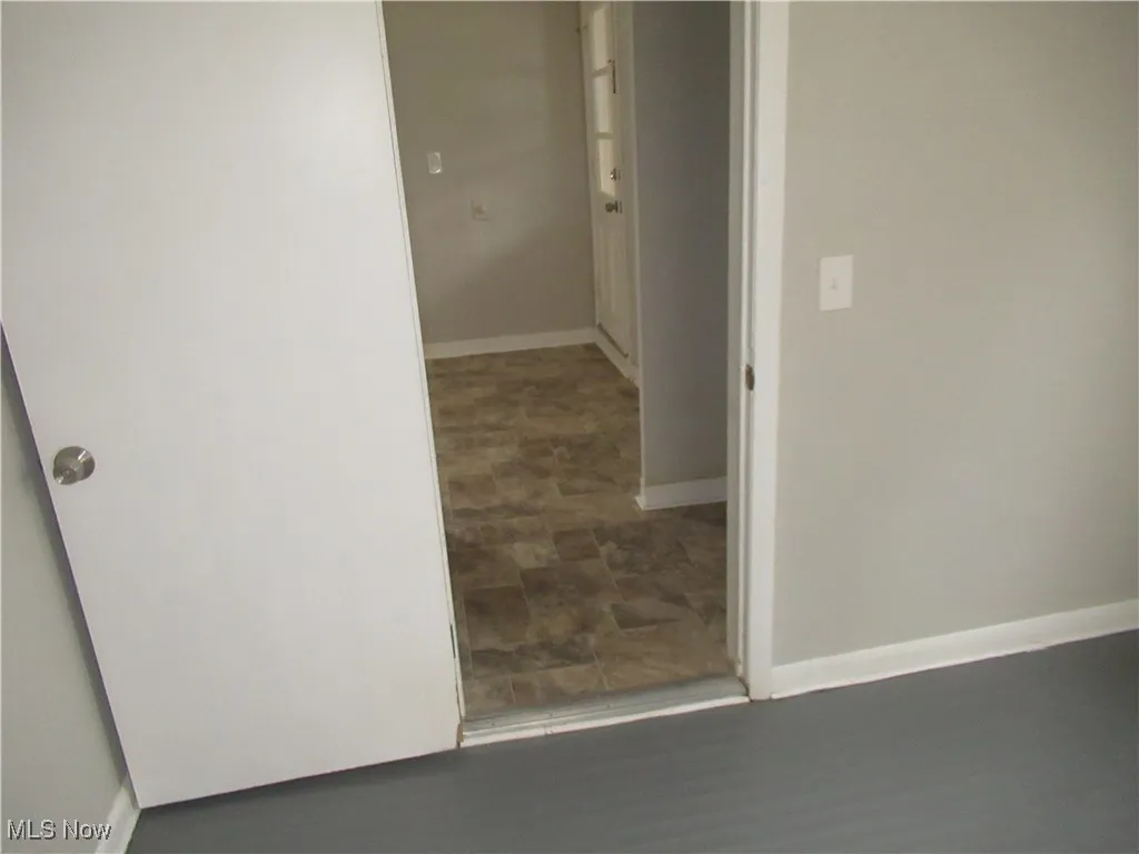 Corridor featuring baseboards