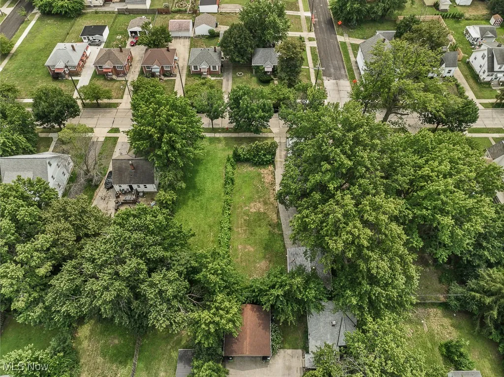 Aerial view of home with 2 vacant lots attached