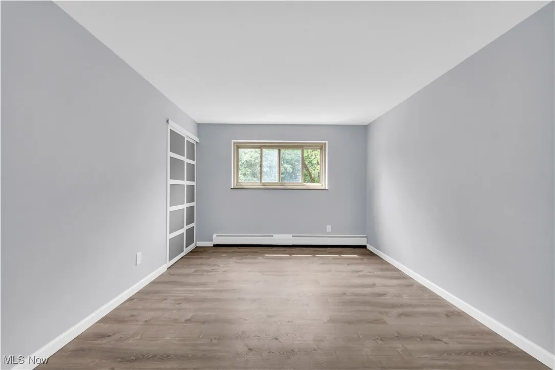 Spare room with light wood-style flooring and baseboard heating