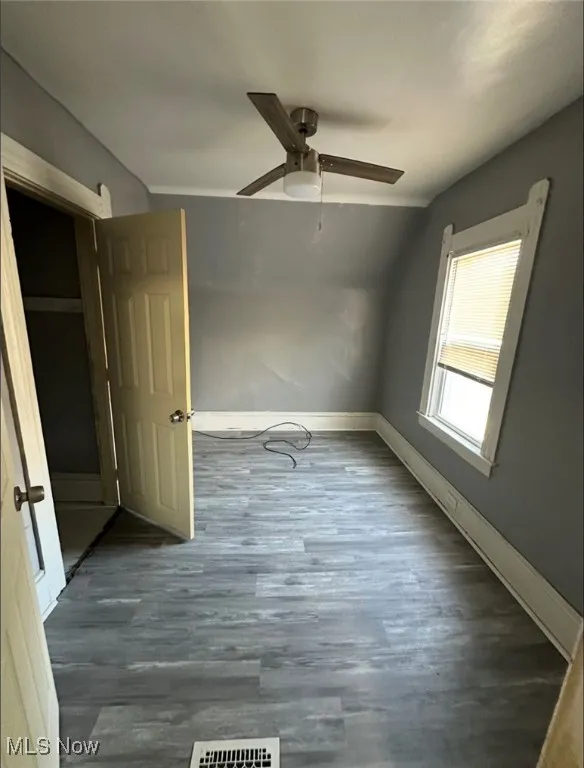 Unfurnished bedroom featuring wood finished floors and a ceiling fan