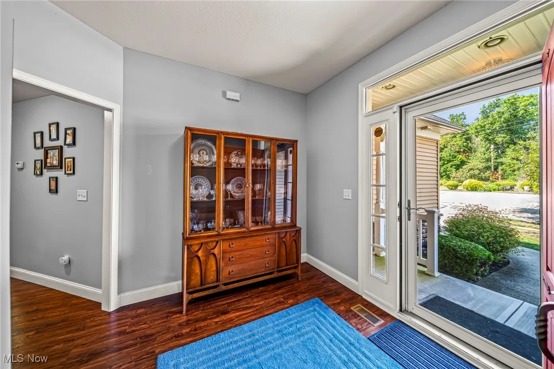 Entryway with baseboards and dark wood finished floors
