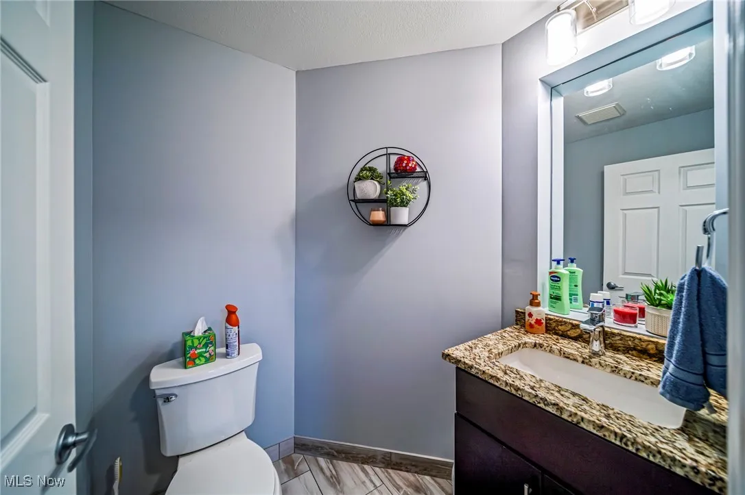 Half bathroom with toilet and vanity
