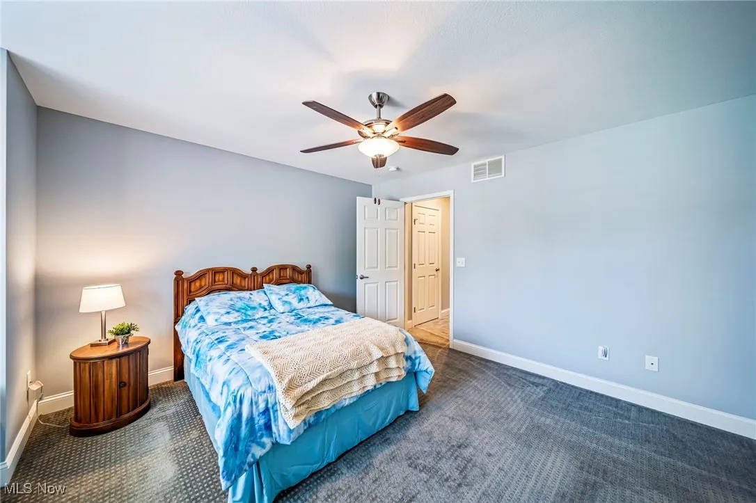Bedroom featuring ceiling fan and carpet floors