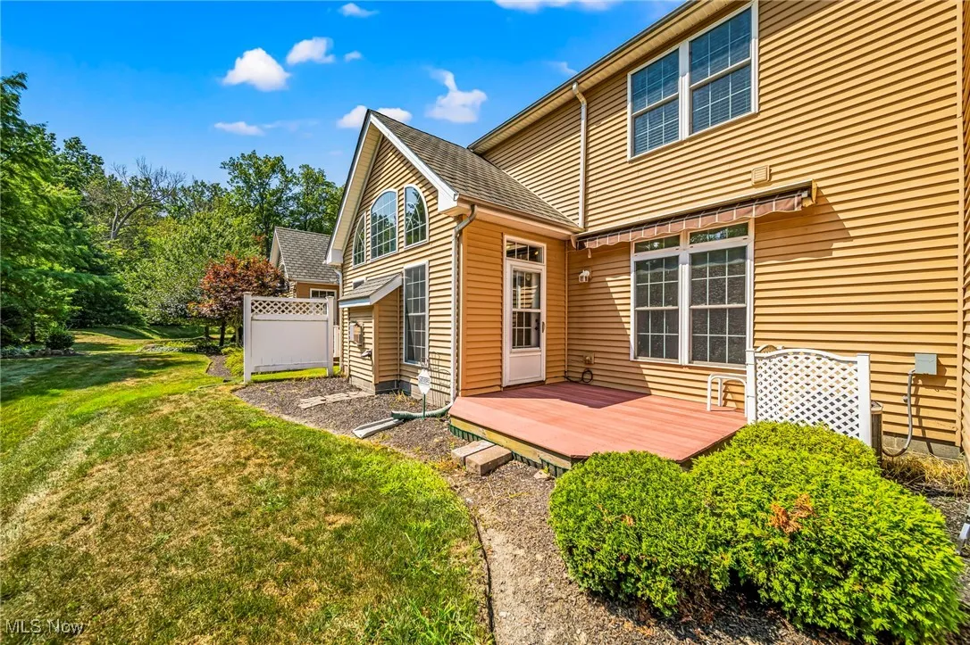 Rear view of property featuring a wooden deck