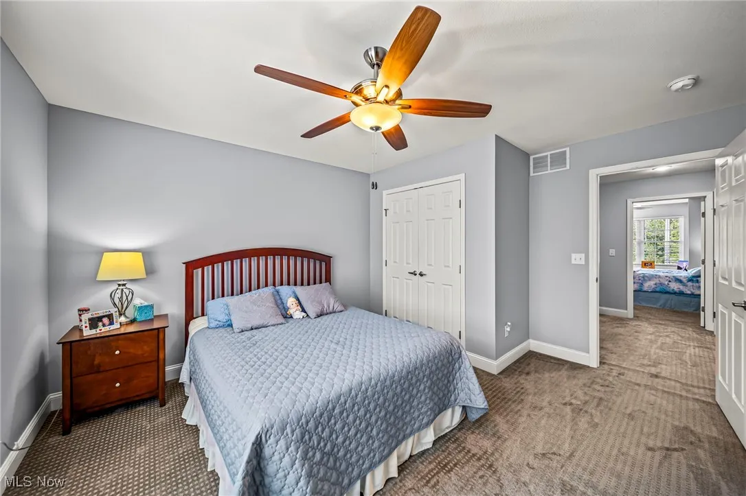 Bedroom with carpet flooring, a closet, and ceiling fan