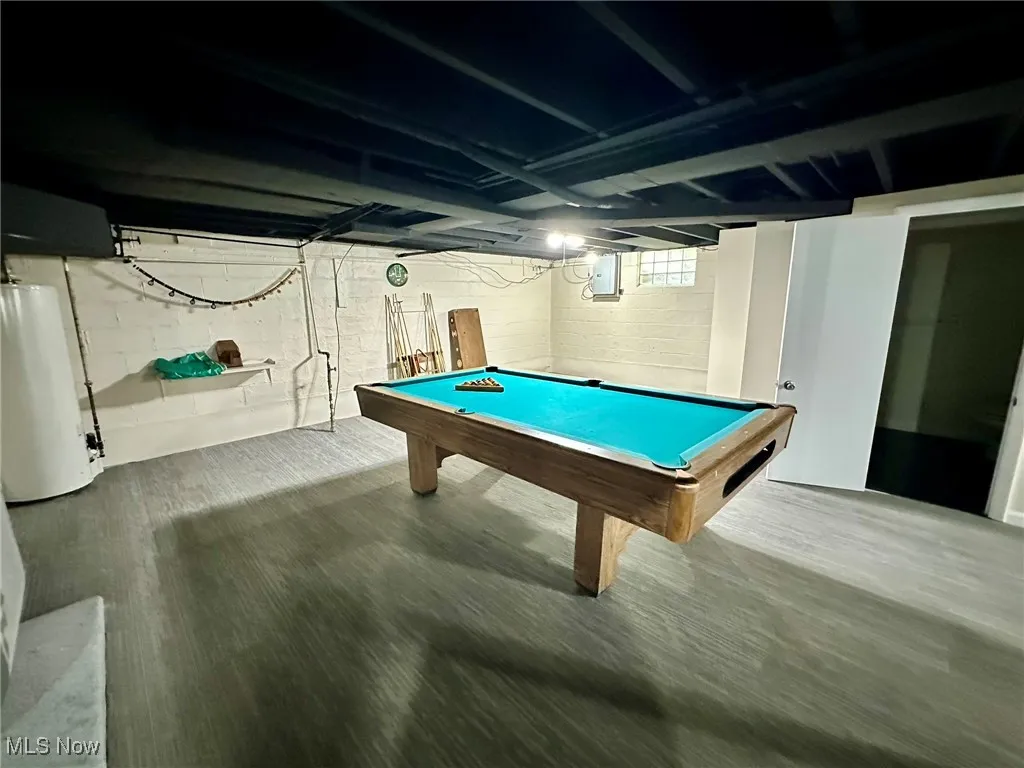 Playroom featuring billiards table, gas water heater, and wood finished floors