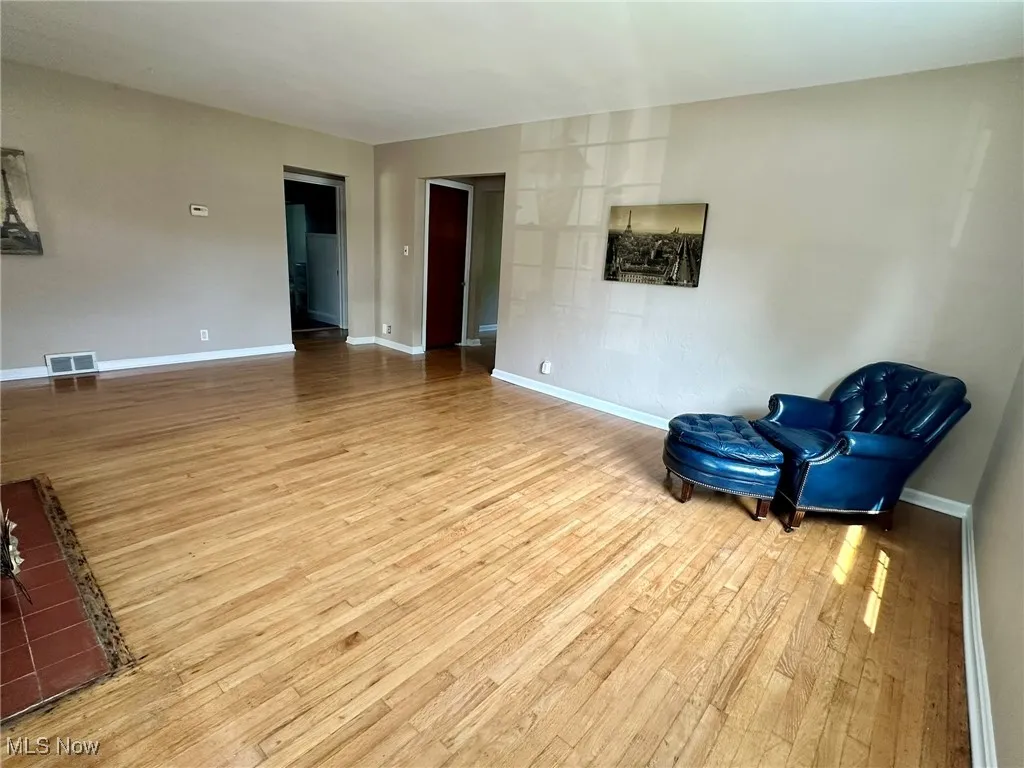 Unfurnished room with light wood-style flooring and baseboards