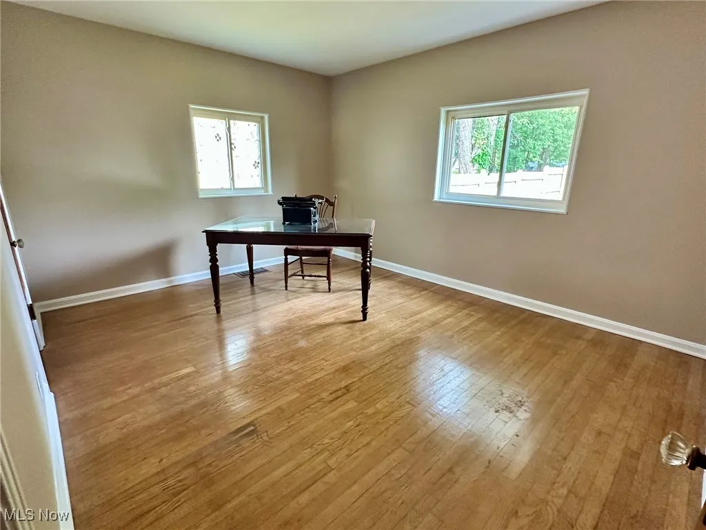 Office area with light wood-type flooring and baseboards