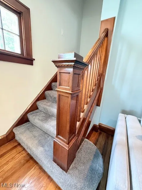 Stairway featuring wood finished floors and baseboards