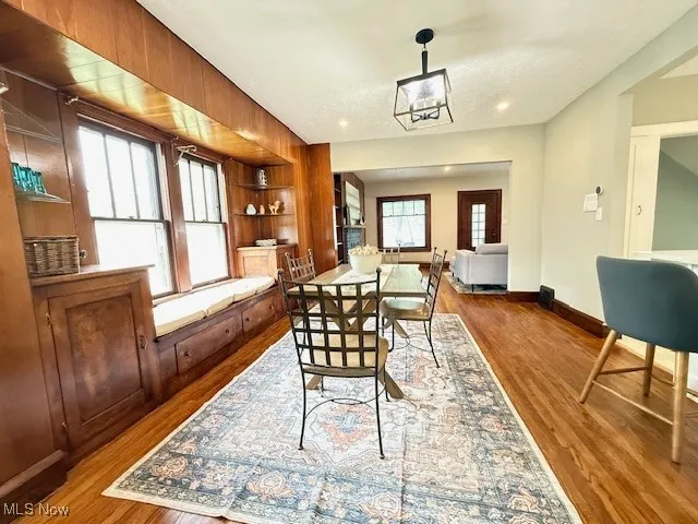 Dining space featuring light wood-style floors, built in shelves, and recessed lighting