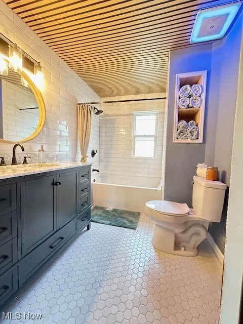 Bathroom with shower / bath combo and vanity