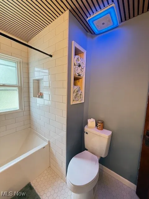 Bathroom featuring shower / tub combination and tile patterned floors